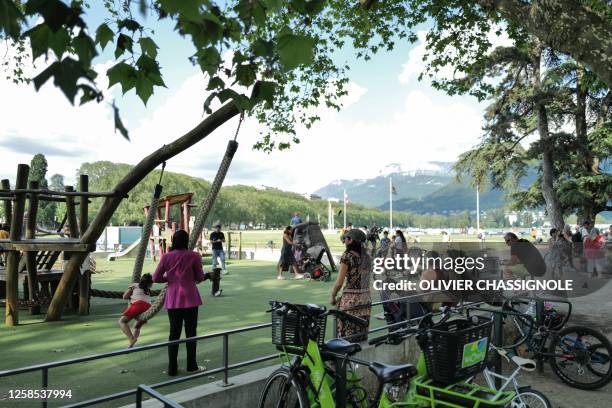 Local residents and children come to a playground in the 'Jardins de l'Europe' in Annecy, in the French Alps, on June 8 following a mass stabbing in...