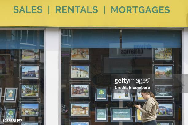 Property adverts in the window of an estate agent's in Wakefield, UK, on Thursday, June 8, 2023. UK house prices posted their first annual decline...