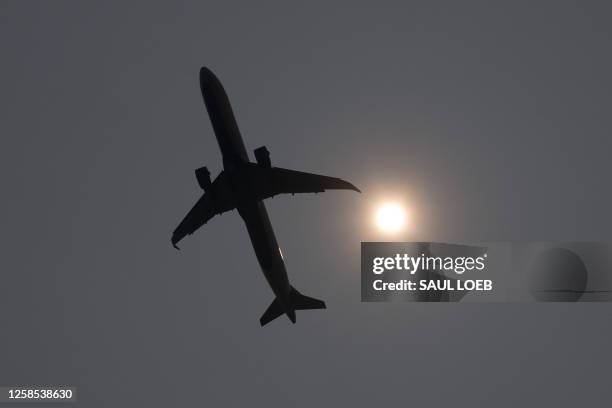 Delta Airbus A321 airplane takes off into a smoke haze from Ronald Reagan Washington National Airport in Arlington, Virginia, June 8 as smoke from...