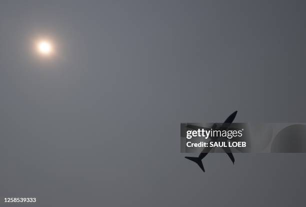 Southwest Boeing 737 airplane takes off into a smoke haze from Ronald Reagan Washington National Airport in Arlington, Virginia, June 8 as smoke from...