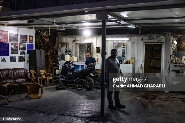 Man stands near blood stains at a car wash, where five Arab Israelis were shot dead, in the village of Yafia, west of Nazareth, on June 8, 2023. In...