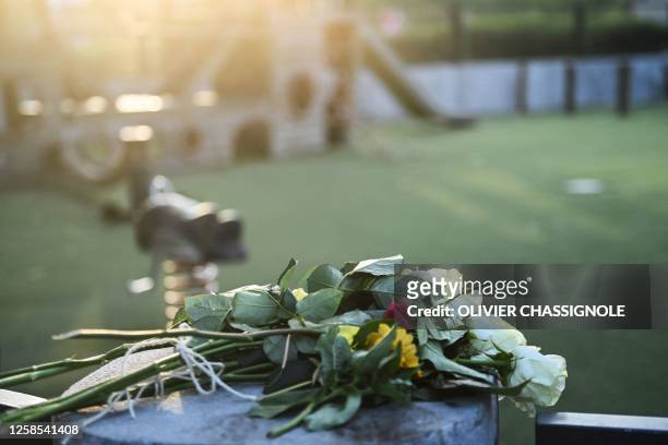 Flowers for the victims are placed at a playground in the 'Jardins de l'Europe' in Annecy, in the French Alps, on June 8 following a mass stabbing in...