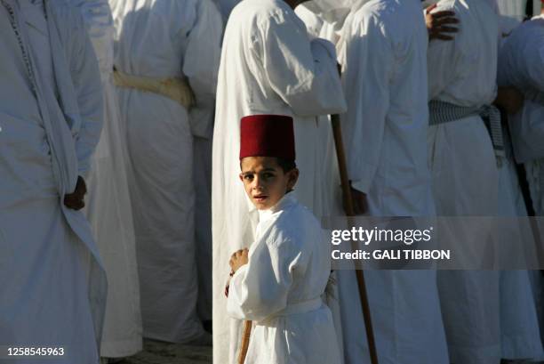 Samaritan boy looks on as older members of the ancient community pray at their most sacred site at Mount Gerizim in the northern West Bank, during...