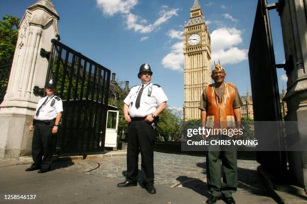 Bushman leader Roy Sesana of the Kalahari stands outside Britain's Houses of Parliament in central London, 23 May 2007, as he prepares to meet with...