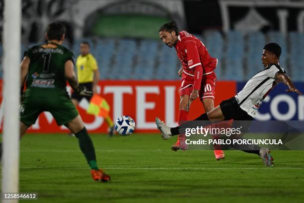 Huracan's midfielder Lucas Castro kicks the ball past Danubio's Colombian midfielder Jannenson Sarmiento during the Copa Sudamericana group stage...