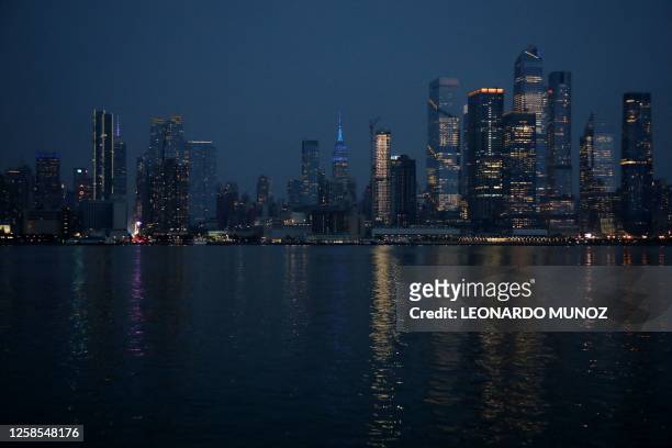 The skyline of midtown Manhattan, New York, as seen from across the Hudson river in Weehawken, New Jersey, on June 8, 2023. Smoke from Canadian...