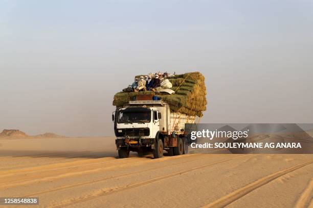 Truck carrying food for humanms and animals crossing the Sahara desert are seen in the area of Djado in Niger, towards the Libyan border, on May 22,...