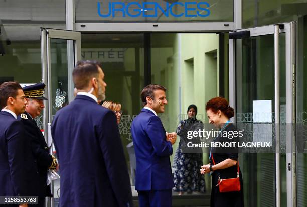 France's President Emmanuel Macron is welcomed by Grenoble CHU director Monique Sorrentino as he arrives to visit the victims of a knife attack at...