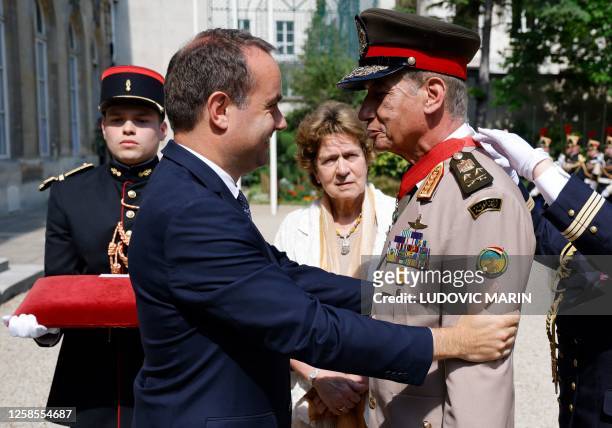 France's Armies Minister Sebastien Lecornu looks at Egypte's Defence minister Lieutenant General Mohamed Zaki receiving the Legion of Honour medal...