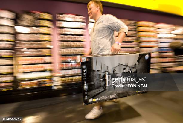 Fan rushes to the tills at the HMV music store in Oxford Street, central London during the rush to purchase the new Beatles Rock Band interactive...