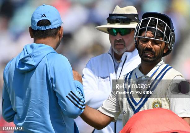 India's Ajinkya Rahane receives treatment to his hand after being hit by the ball during play on day 3 of the ICC World Test Championship cricket...