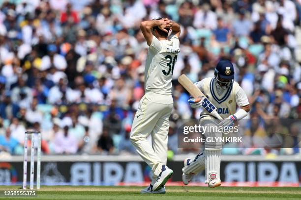 Australia's Pat Cummins reacts as India's Ajinkya Rahane adds runs after a catch was dropped during play on day 3 of the ICC World Test Championship...