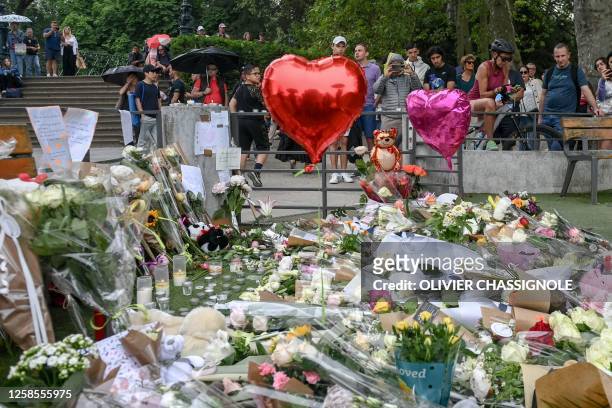 This photograph taken on June 9 shows flowers, candles and balloons laid in the 'Jardins de l'Europe' parc in Annecy, French Alps, for the victims of...