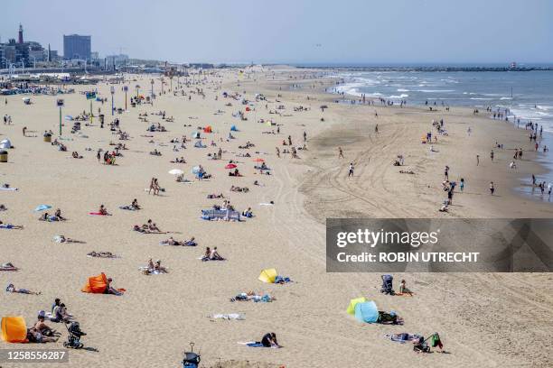 People sunbathe on the beach in Schevenigen, near the Hague, on June 9, 2023. / Netherlands OUT
