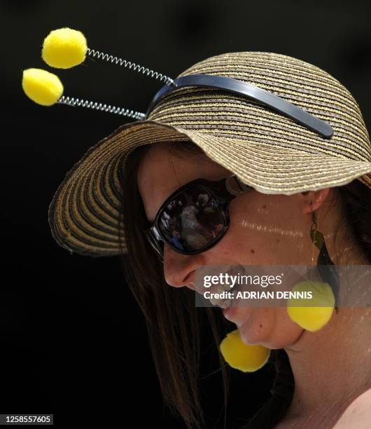 Spectator wears a fancy disguise as she attends a tennis match between Croatia's Ivo Karlovic and Switzerland's Roger Federer on Day 9 at the 2009...