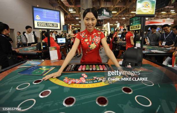 Croupier attends a table at the Global Gaming Expo Asia in Macau on June 9, 2010. Asia's gaming market could overtake the US in as little as three...