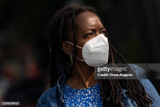 Woman wears a face mask during the morning commute due to a code orange air quality alert because of smoke from Canadian wildfires on June 9, 2023 in...