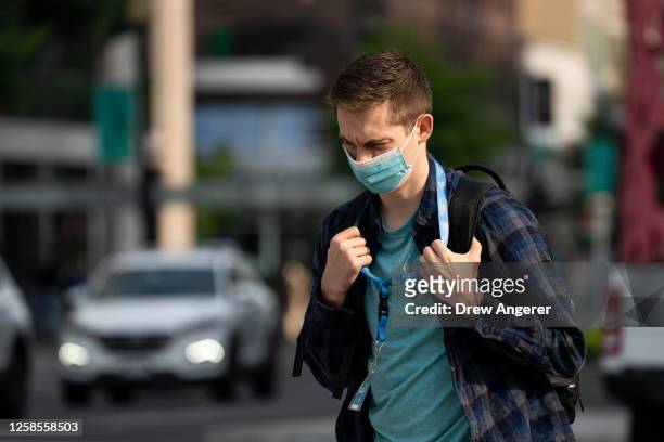 Man wears a face mask during the morning commute due to a code orange air quality alert because of smoke from Canadian wildfires on June 9, 2023 in...
