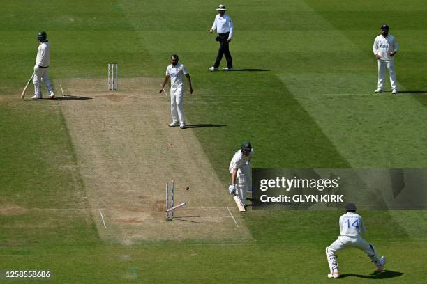 Australia's Marnus Labuschagne reacts as he makes it back to his crease just before the ball, hits the stumps knocking the bails flying, during play...