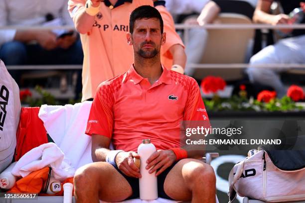 Serbia's Novak Djokovic waits on the bench as Spain's Carlos Alcaraz Garfia left the court for a medical break during their men's singles semi-final...