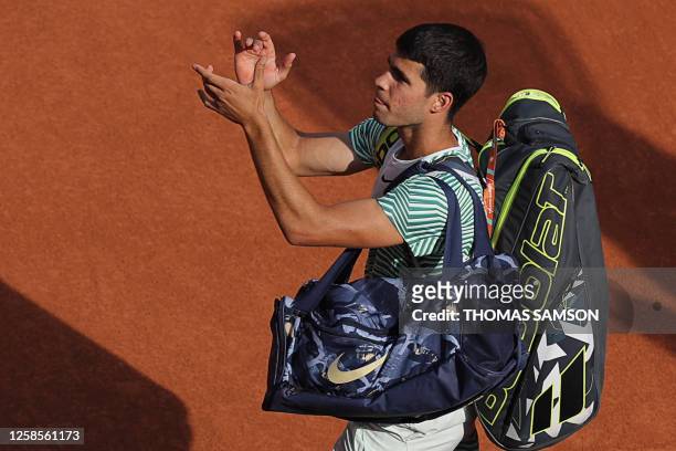 Spain's Carlos Alcaraz Garfia applauds as he leaves the court after being defeated by Serbia's Novak Djokovic during their men's singles semi-final...