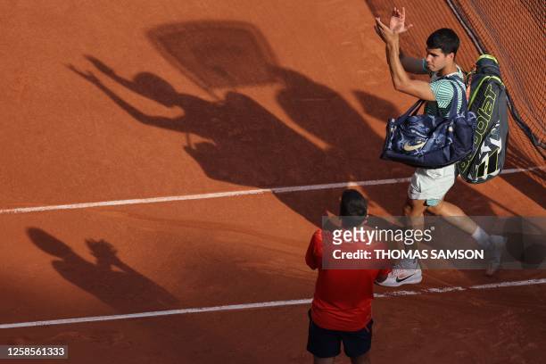 Spain's Carlos Alcaraz Garfia applauds as he leaves the court after being defeated by Serbia's Novak Djokovic during their men's singles semi-final...