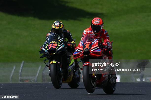 Ducati Team's Italian rider Francesco Bagnaia and Team VR46's Italian rider Marco Bezzecchi compete during a practice session ahead of the Italian...