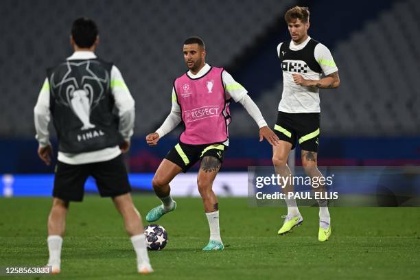 Manchester City's English defender Kyle Walker and Manchester City's English defender John Stones take part in a training session at the Ataturk...