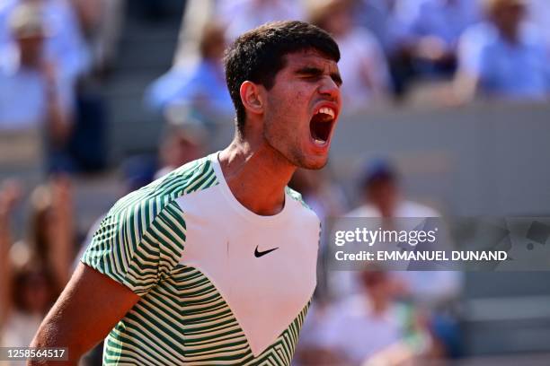 Spain's Carlos Alcaraz Garfia shouts as he celebrates a point against Serbia's Novak Djokovic during their men's singles semi-final match on day...