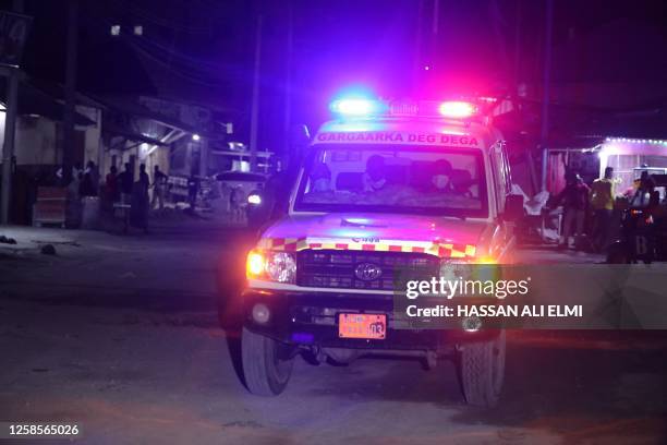 An ambulance is seen outside the perimeter of a rescue operations in Mogadishu on June 9, 2023 during an attack. Rebels from the Islamist Al-Shabaab...