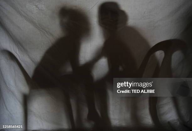 Lifestyle-IT-Philippines-crime-pornography-child,FEATURE" by Cecil Morella The shadow of two teenage girls rescued from a cyber sex den is seen in...