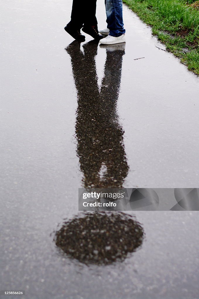 Reflection of couple kissing