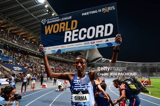 Ethiopia's Lamecha Girma celebrates after breaking the World record in the men's 3000m steeplechase event during the IAAF Diamond League "Meeting de...