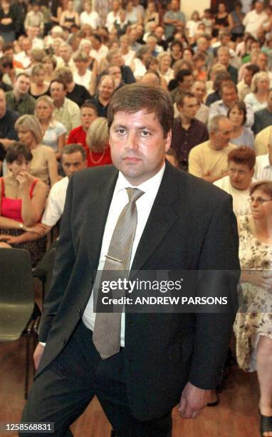Andy Hebb in front of members of the local community in the town of Soham, Cambridgeshire attend a meeting 15 August 2002 with the community police...