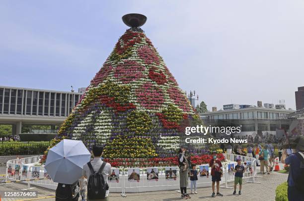 The "flame of peace" burns on top of an 8-meter tower decorated with about 8,000 flower pots, as a two-day flower festival opens at the Peace...