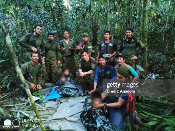 Colombian Military Forces pose for a photo as they found four children who survived 40 days in the Amazon jungle after their plane crashed, in the...