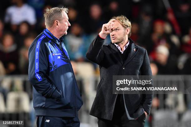Drua's head coach Mick Bryne talks with the Crusaders' coach Scott Robertson prior to the start of the Super Rugby quarter-final match between the...