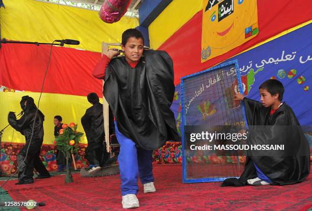 Afghan children rehearse for a performance on child labour at the Afghan Mobile Mini Circus for Children in Kabul on June 11, 2011. The Mobile Mini...
