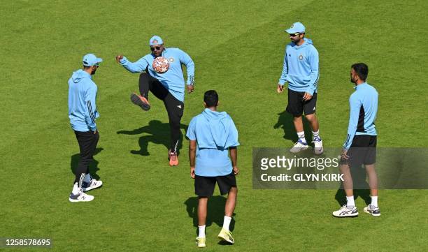 Indian cricketers and support staff warm up with a game of football prior to play on day 4 of the ICC World Test Championship cricket final match...