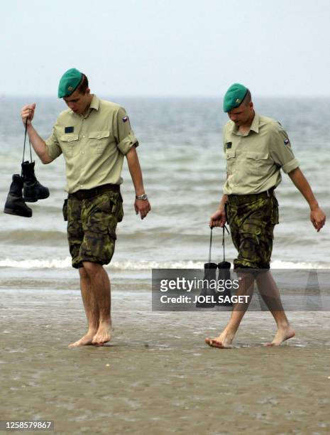 Two Czech Republic soldiers walk on the sand of Utah Beach 05 June 2004 at Sainte Marie du Mont where the WWII allied forces landed 06 June 1944....