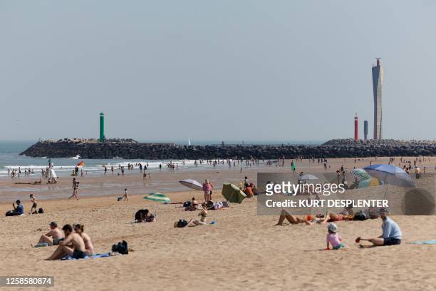 People enjoy spending time on the beach in Ostend, northwestern Belgium, June 10, 2023. The Royal Meteorological Institute of Belgium forecasts...