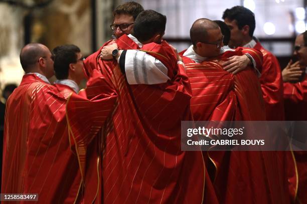 Fifteen new Catholic priests congratulate each other at the end of an ordination mass celebrated the Archbishop of Milan, in the Duomo Cathedral in...
