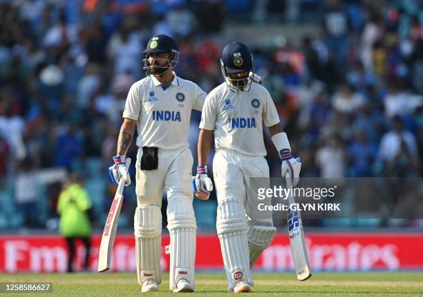 India's Virat Kohli embraces teammate India's Ajinkya Rahane as they walk off the field at stumps on day 4 of the ICC World Test Championship cricket...