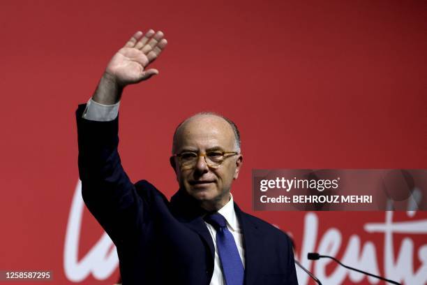 Former French prime minister and founder of the "La Convention" party Bernard Cazeneuve waves at the end of his speech during the first public...