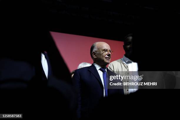 Former French prime minister and founder of the "La Convention" party Bernard Cazeneuve stands on stage after his speech during the first public...