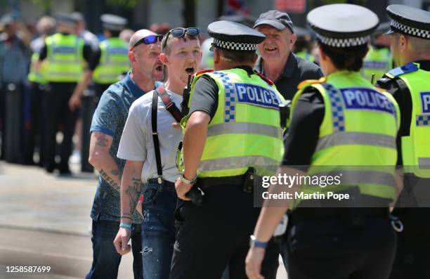 Protesters clash with police officers as rival groups are kept apart in the city centre on June 10, 2023 in Leeds, England. Protesters gathered to...
