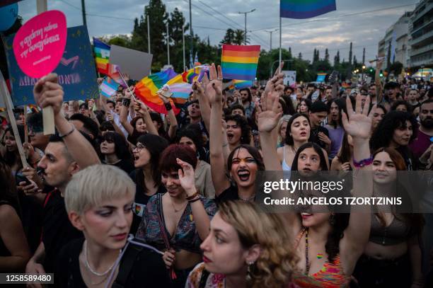 Participants dance in front of the Greek parliament during the Athens Pride parade in Athens, on June 10, 2023.