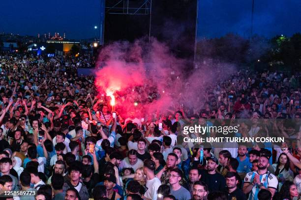 Supporters of Manchester City light flares as they gather in the Manchester City Fan Zone in Istanbul ahead of the UEFA Champions League final match...