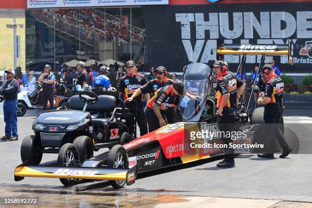 The crew of the Leah Pruett pushes the car to the line during the NHRA Thunder Valley Nationals on June 10, 2023 at the Bristol Dragway in Bristol,...
