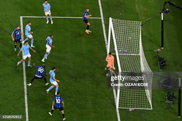 Manchester City's Brazilian goalkeeper Ederson saves a shto from Inter Milan's Belgian forward Romelu Lukaku during the UEFA Champions League final...